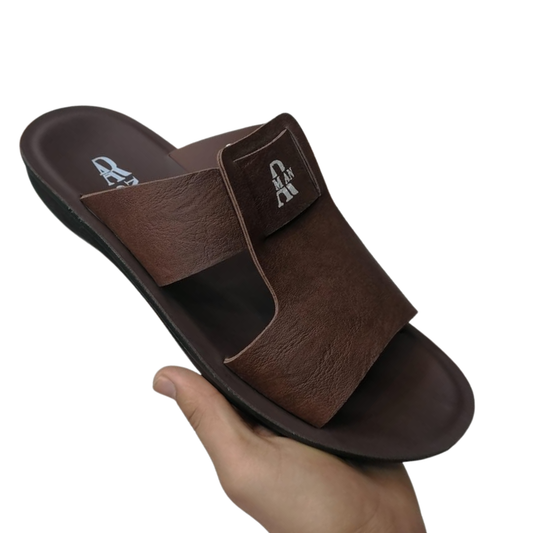Brown slide Slipper held by a hand on a white background