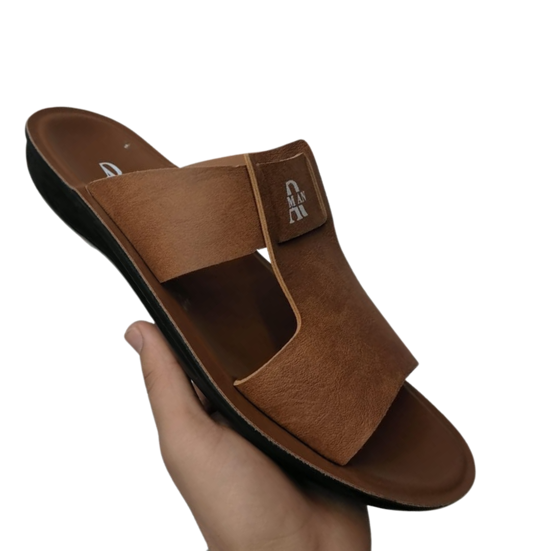 Mustard TAN slipper for men held by a hand on a white background